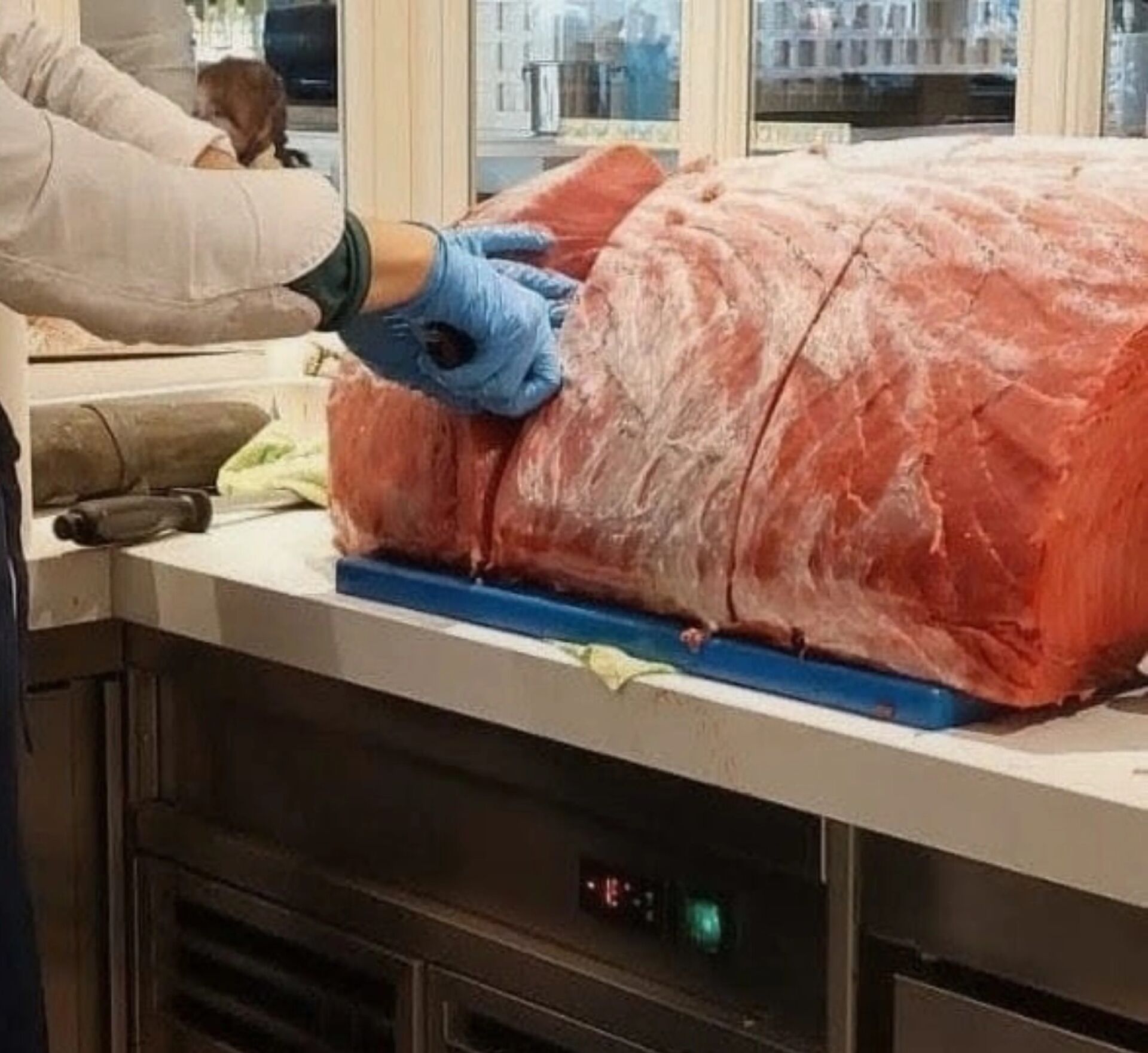 Whole loin of tuna being portioned in the kitchen